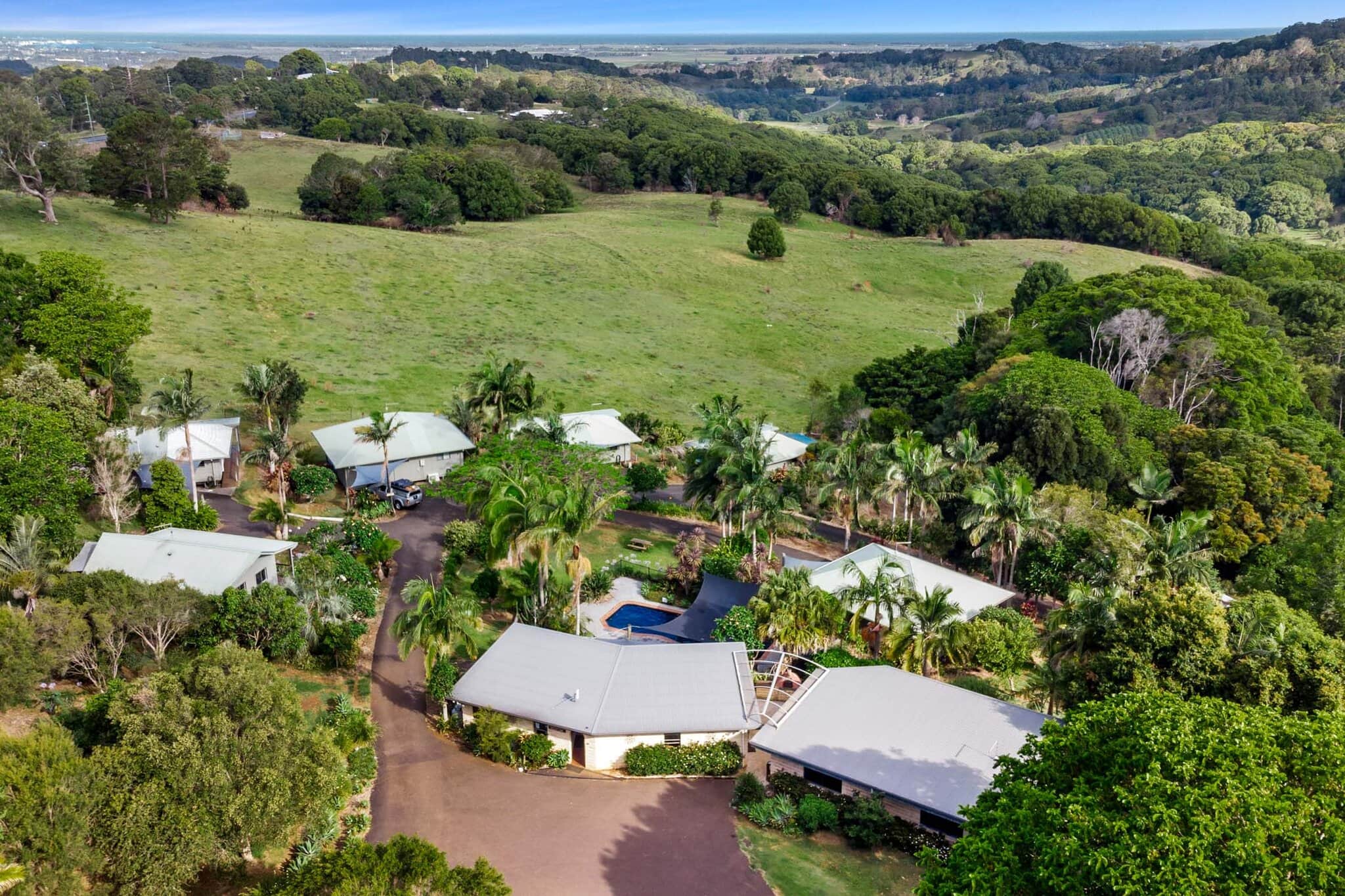 Aerial view of Alstonville Country Cottages nestled in lush green hinterland with sweeping valley views