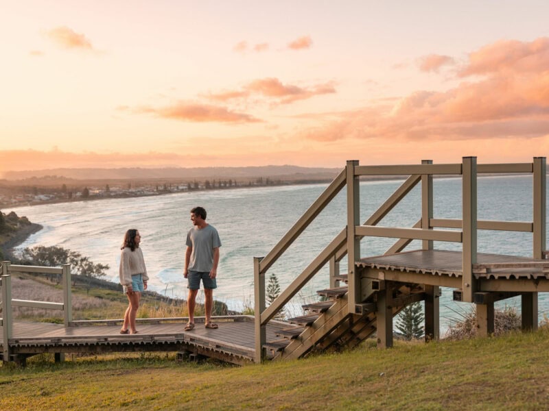 Couple enjoying sunset views at Pat Morton Lookout in Lennox Head, NSW