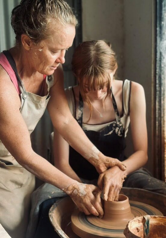 Potter Brooke Clunie guiding a participant during a hands-on clay workshop in the Ballina Hinterland, Northern NSW